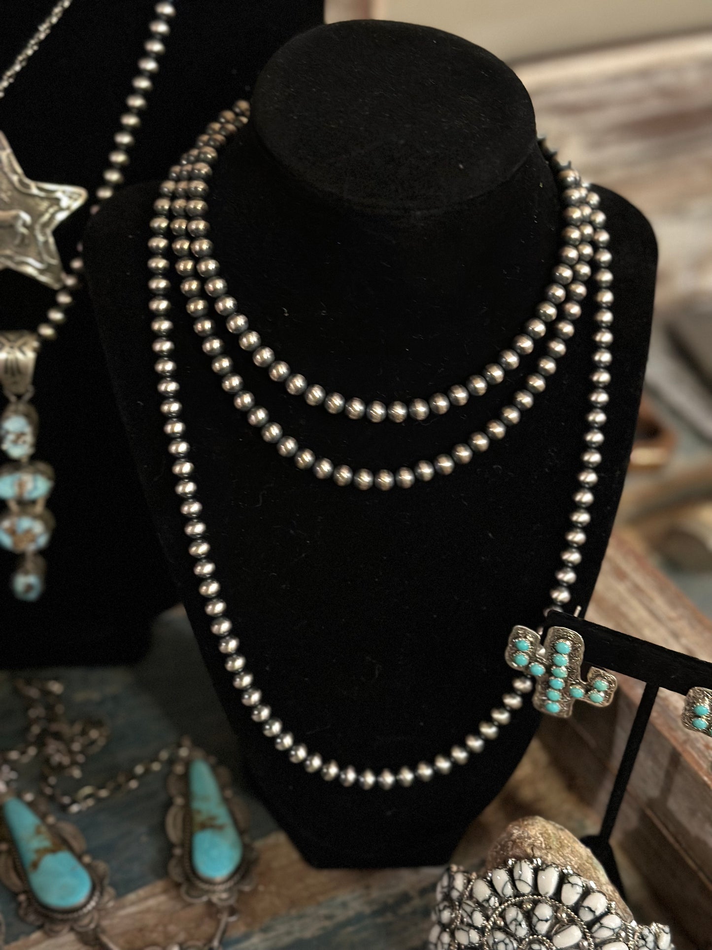 Necklace of 6mm Navajo pearls, shown layered with additional strands of varying lengths to create a beautiful layered look of silver pearls